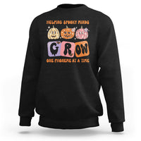 Black Halloween reading sweatshirt with “GROW” phoneme graphic and orange text