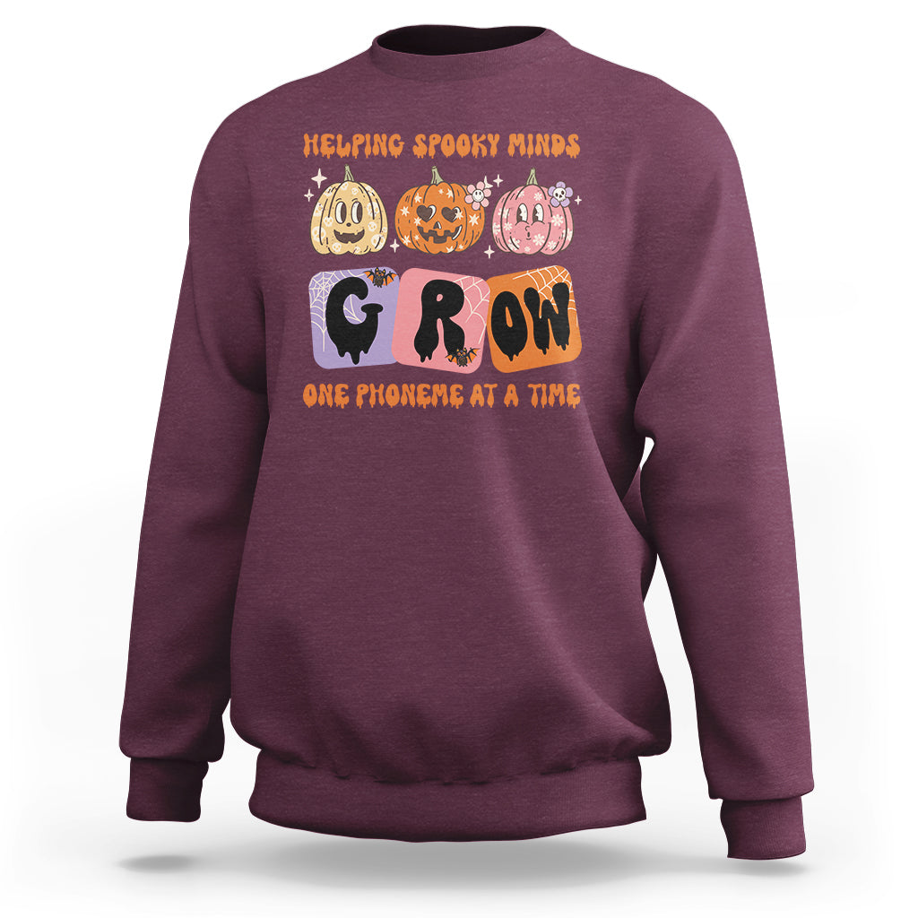 Maroon Halloween reading sweatshirt with “GROW” phoneme graphic and orange text