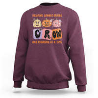 Maroon Halloween reading sweatshirt with “GROW” phoneme graphic and orange text