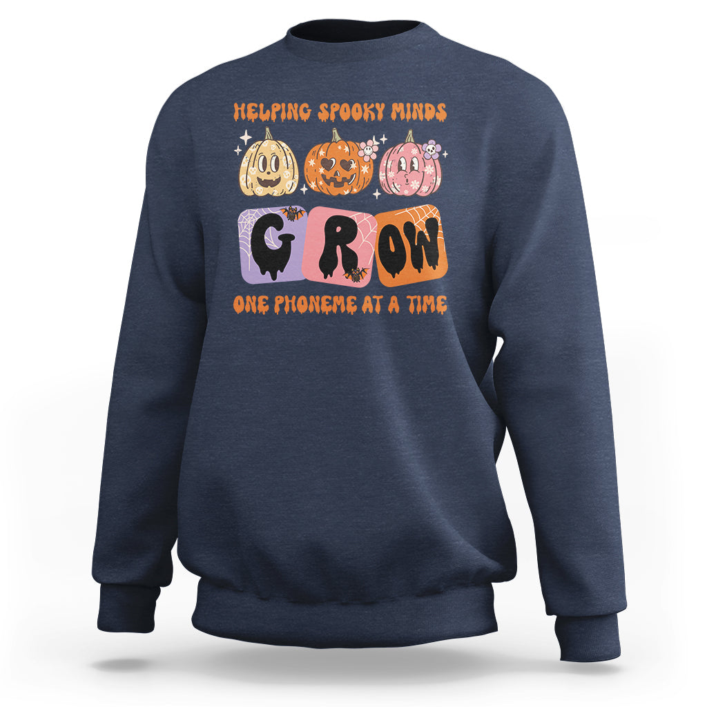 Navy Halloween reading sweatshirt with “GROW” phoneme graphic and orange text