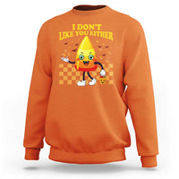 Orange crewneck sweatshirt with candy corn character and 'I DON'T LIKE YOU EITHER' graphic