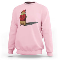 Light pink crewneck sweatshirt with cartoon groundhog shadow graphic on chest.