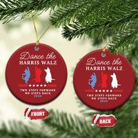 Pair of red Christmas ornaments hanging on pine, with dancer silhouettes and front/back tags