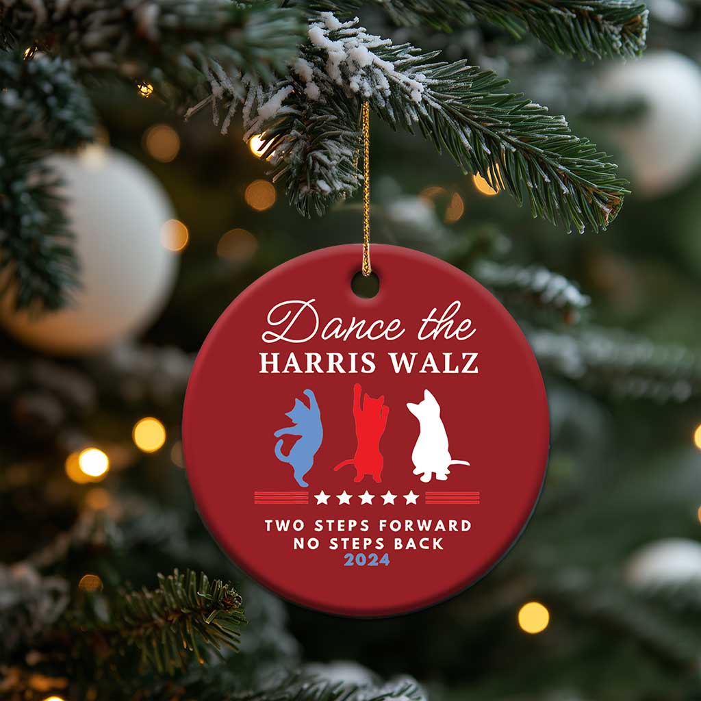 Red round Christmas ornament hanging from pine needles, with dancer silhouettes and 2024 text