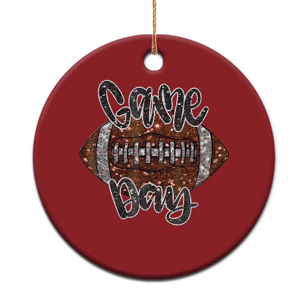 Red round ornament with “Game Day” lettering and a decorated football graphic