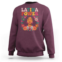 Maroon crewneck sweatshirt with "Latina Power" floral portrait graphic on front