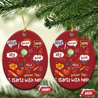 Two red round Christmas ornaments with “it starts with hello” and language greetings, gold strings.