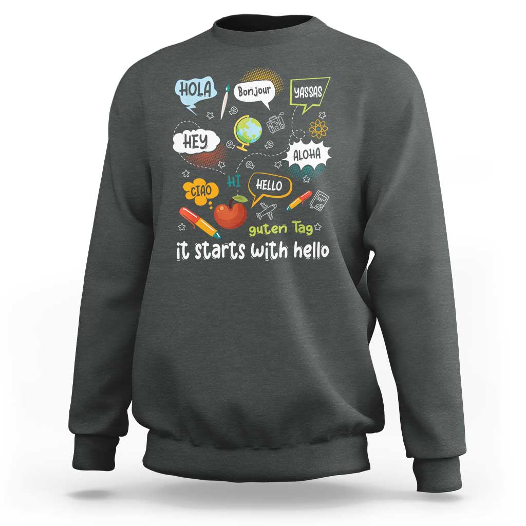 Inclusion Matters sweatshirt, dark heather crewneck with colorful multilingual “it starts with hello” graphic