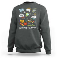 Inclusion Matters sweatshirt, dark heather crewneck with colorful multilingual “it starts with hello” graphic
