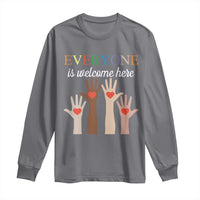 Charcoal long sleeve shirt with “Everyone is welcome here” heart-hand graphic