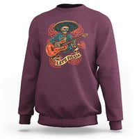 Maroon crewneck sweatshirt with skeleton guitarist fiesta graphic on front.