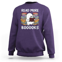 Purple Halloween reading sweatshirt with a cute ghost reading, stacked book graphic and “READ MORE BOOOOKS”.
