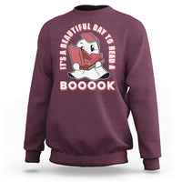 Maroon Halloween sweatshirt with ghost reading book graphic and 'BOOOOK' text.