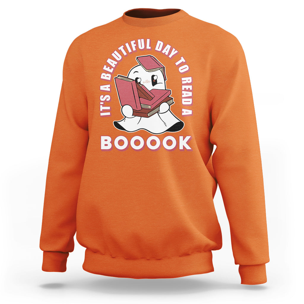 Orange Halloween sweatshirt with ghost reading book graphic and 'BOOOOK' text.