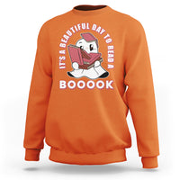 Orange Halloween sweatshirt with ghost reading book graphic and 'BOOOOK' text.