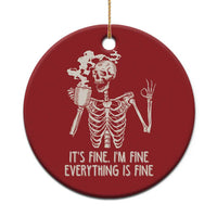 Red round Christmas ornament with white skeleton holding a coffee mug and text, hanging loop