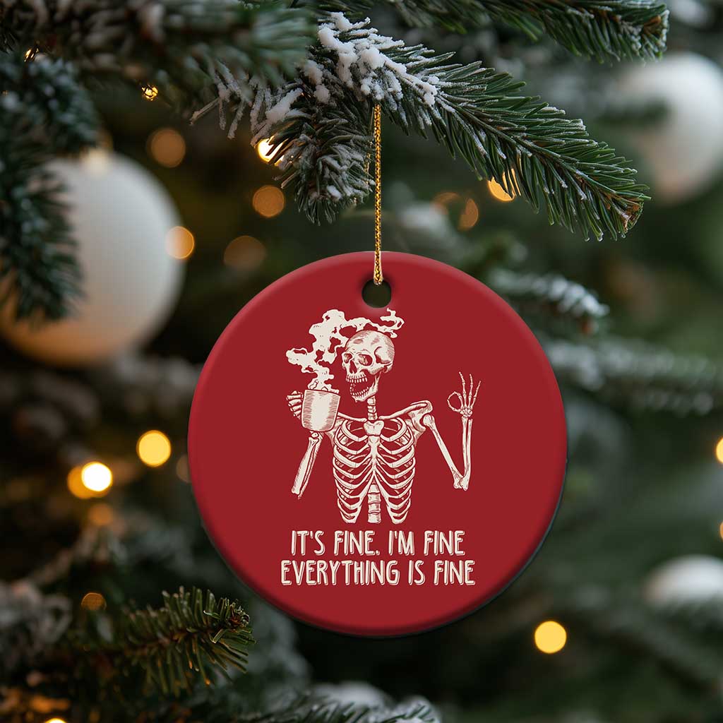 Red round Christmas ornament featuring a white skeleton with coffee mug and “IT’S FINE...” text