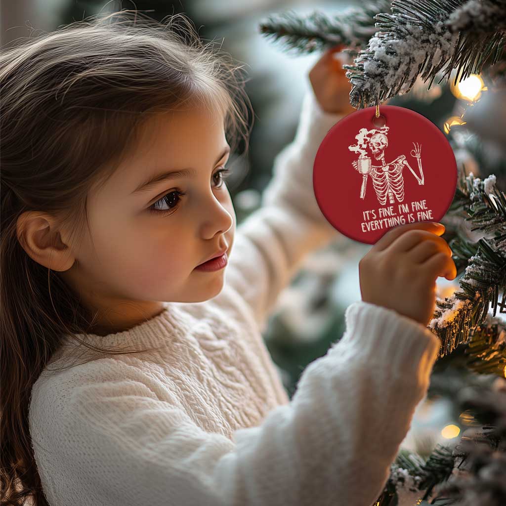 Red round skeleton Christmas ornament with white coffee-mug graphic and “IT’S FINE...” text
