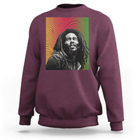 Maroon crewneck sweatshirt with colorful reggae-style portrait graphic on back.