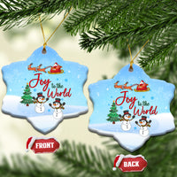 Blue ceramic heart ornaments hanging, Joy to the World with snowmen and sleigh.