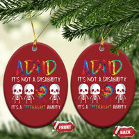 Two red oval ADHD awareness ornaments on pine branches, featuring colorful skull graphic and text.