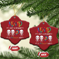 Two red heart-shaped ADHD awareness ornaments on pine branches, each with colorful skull graphic.