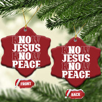 Red heart-shaped Christmas ornaments with white “KNOW JESUS KNOW PEACE” text, hanging from gold strings.