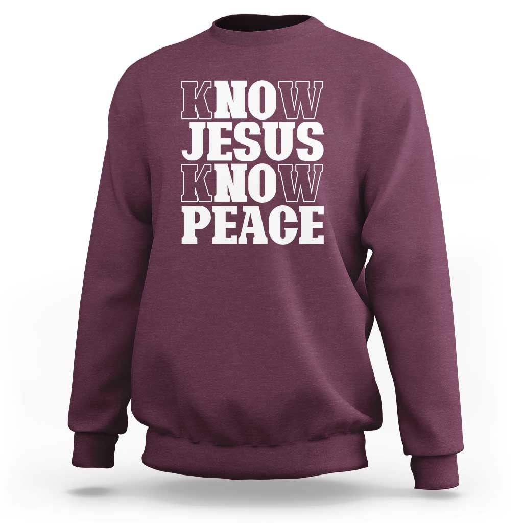 Maroon crewneck sweatshirt with "KNOW JESUS KNOW PEACE" graphic on the front.