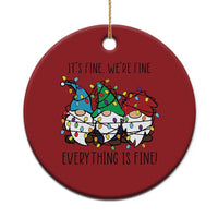 Red round Christmas ornament with gnome illustration and gold hanging loop