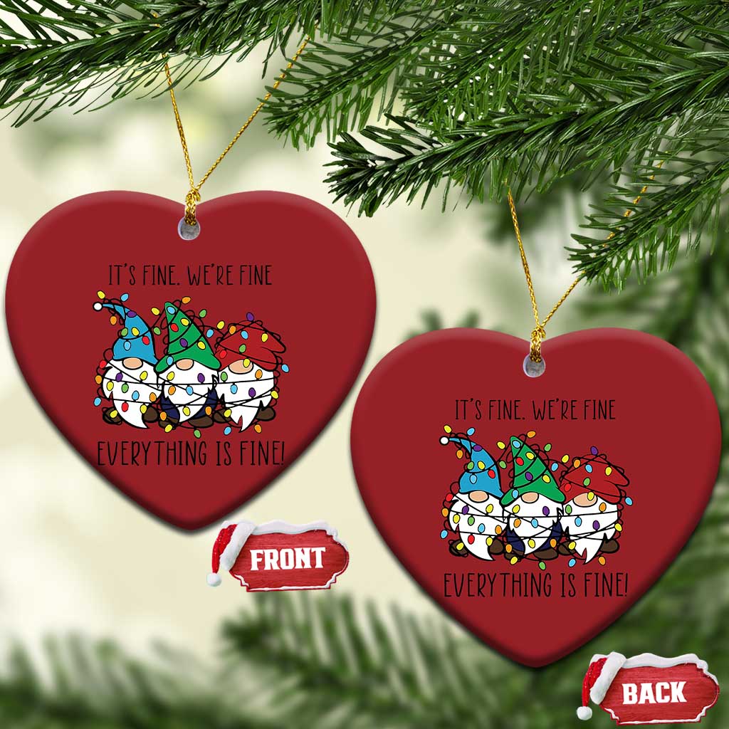 Two red heart-shaped Christmas ornaments with gnome illustration and gold loops