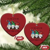 Two red heart-shaped Christmas ornaments with gnome illustration and gold loops
