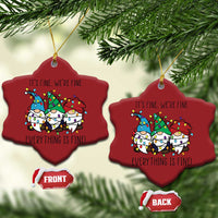 Two red heart-shaped Christmas ornaments with gnome illustration and gold hanging loops