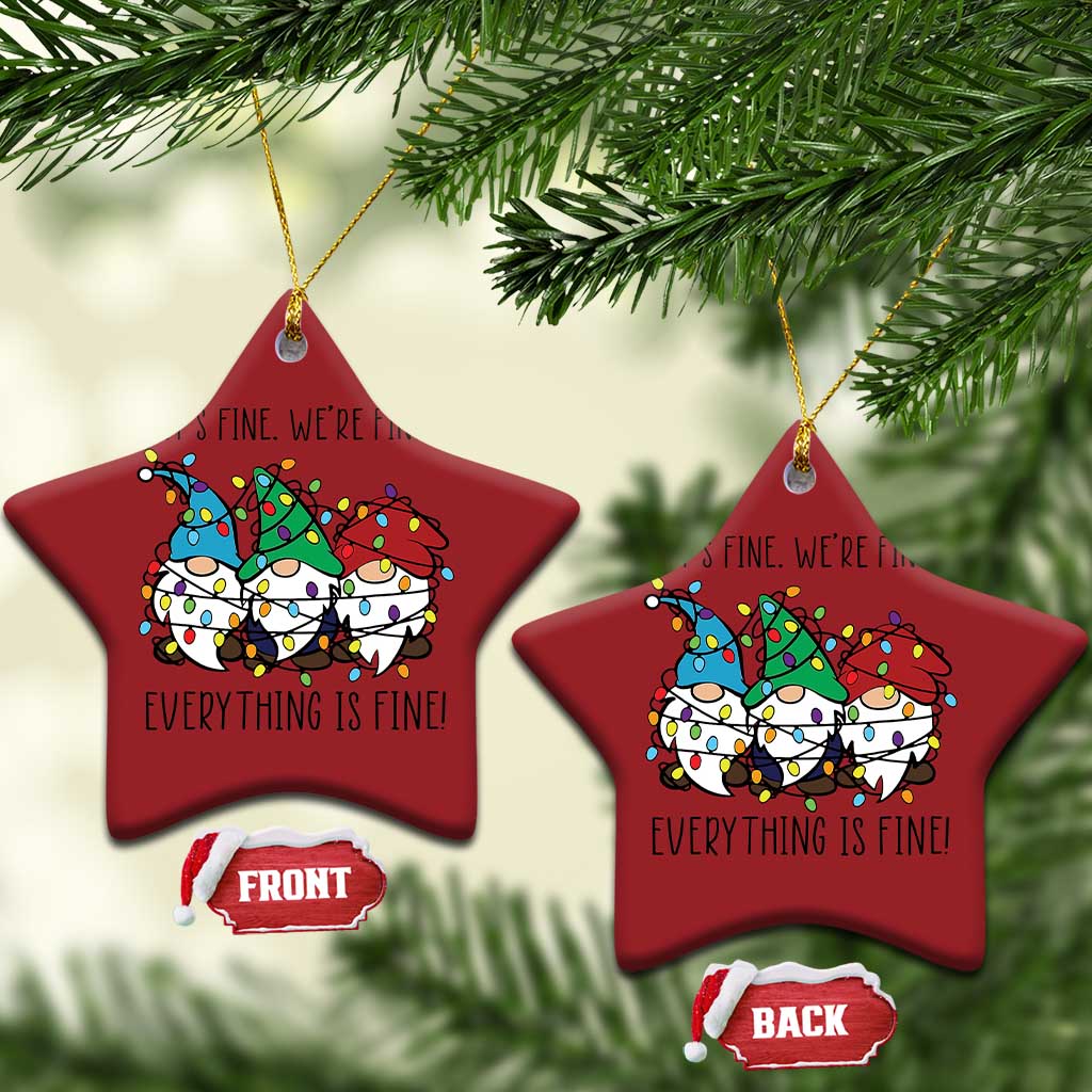 Two red star-shaped Christmas ornaments with gnome illustration and gold hanging loops