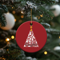 Red round Christmas ornament hanging from a tree branch with white "Daughter" tree design