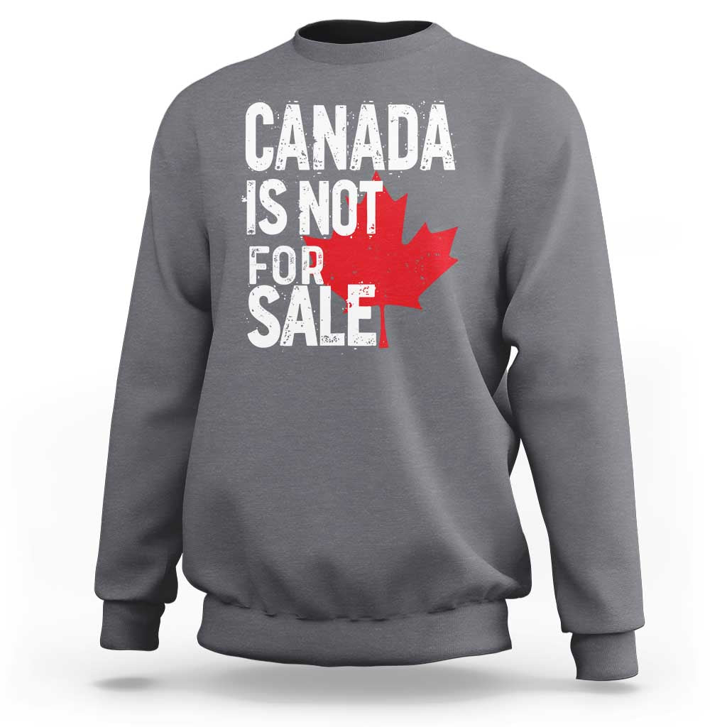 Dark heather crewneck sweatshirt with distressed 'Canada is not for sale' text and red maple leaf.