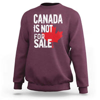 Maroon crewneck sweatshirt with distressed 'Canada is not for sale' text and red maple leaf.