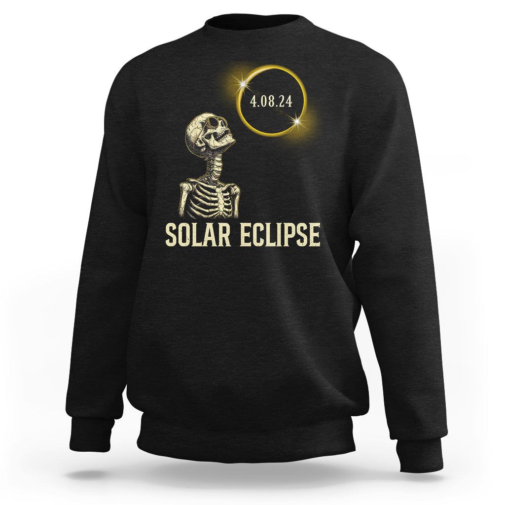 Solar eclipse skeleton sweatshirt in black with gold graphic and date 4.08.24