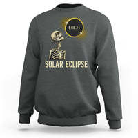 Solar eclipse skeleton sweatshirt in dark gray with gold graphic and date 4.08.24