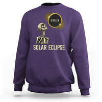 Solar eclipse skeleton sweatshirt in purple with gold graphic and date 4.08.24