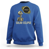 Solar eclipse skeleton sweatshirt in royal blue with gold graphic and date 4.08.24