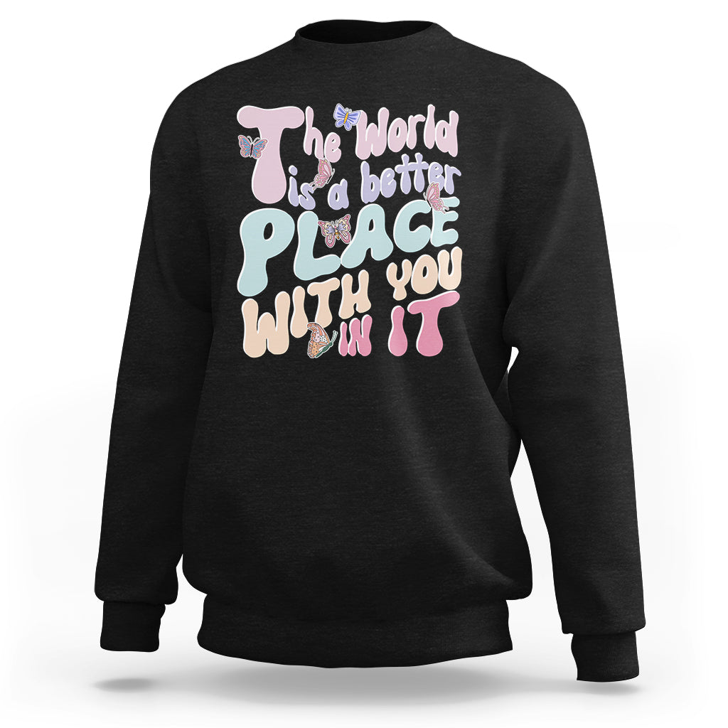 Black crewneck sweatshirt with colorful back graphic reading 'The world is a better place'