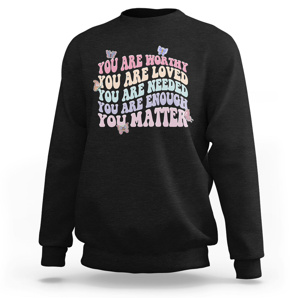 Black sweatshirt with colorful "You are worthy...you matter" chest graphic.