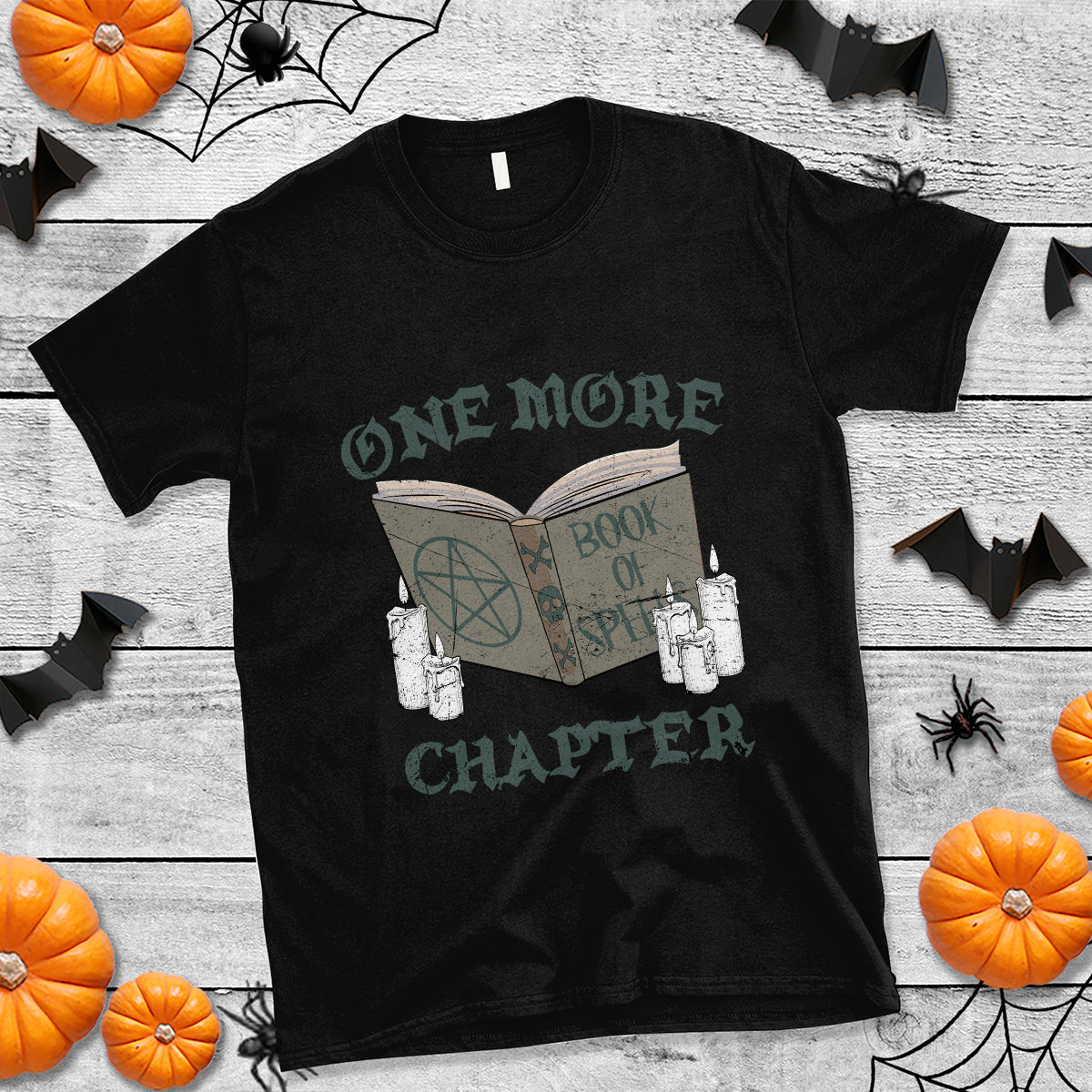 Black crewneck witch graphic T-shirt with open book and spell design on chest