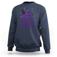 Navy sweatshirt with graphic of a purple witch hat cat and "resting witch face" text