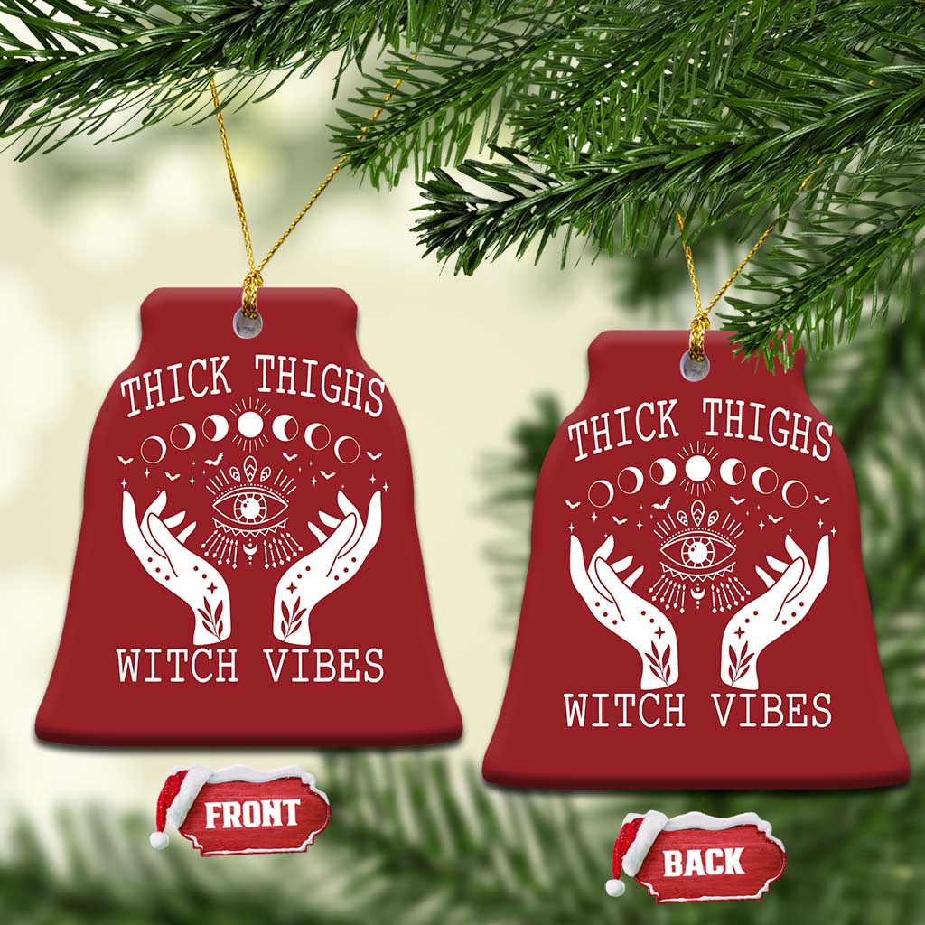 Two red bell-shaped witch vibe ornaments with hanging strings; moon-phase eye and hands graphics
