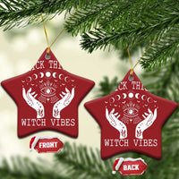 Two red star-shaped witch vibe ornaments with hanging strings; moon-phase eye and hands graphic