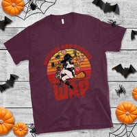 Maroon witch and potions retro graphic T-shirt with orange circular emblem, short sleeves