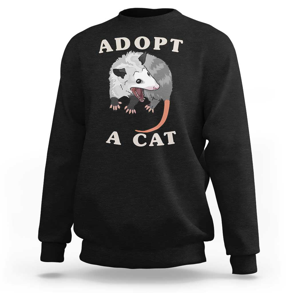 Dark charcoal sweatshirt with 'ADOPT A CAT' graphic on front, crewneck long sleeves