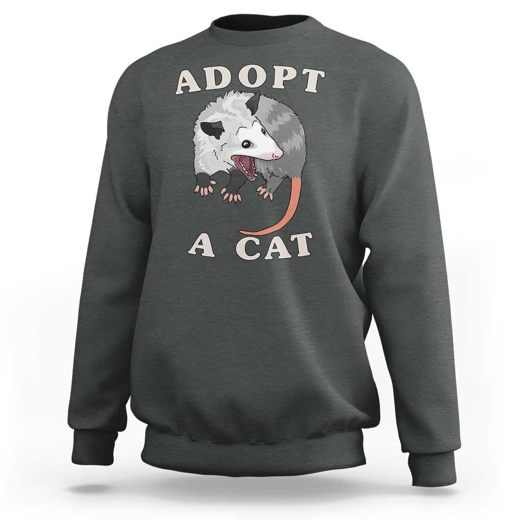 Dark gray sweatshirt with 'ADOPT A CAT' graphic on front, crewneck long sleeves