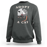 Dark gray sweatshirt with 'ADOPT A CAT' graphic on front, crewneck long sleeves